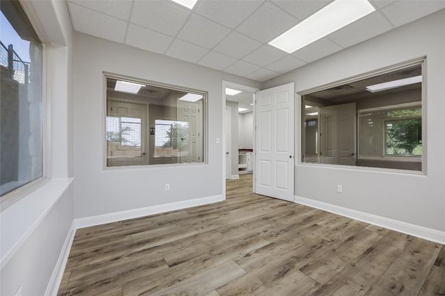 Empty room with baseboards, wood finished floors, and a paneled ceiling | Image 35