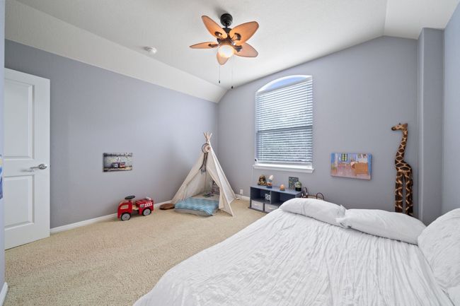 Carpeted bedroom with vaulted ceiling and ceiling fan | Image 23