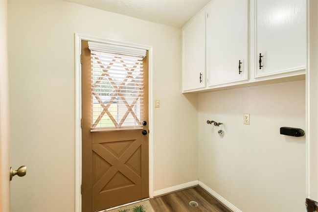Utility room with extra shelving for storage. Gas & electric hookup for the dryer. | Image 19