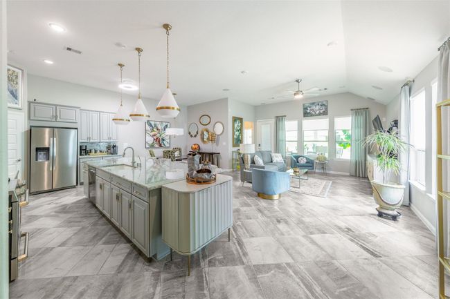 Upon entering, the elegant kitchen catches your eye with its modern appliances, replaced within the last year, and new fans installed in 2024. This space exudes sophistication and thoughtful design. | Image 14