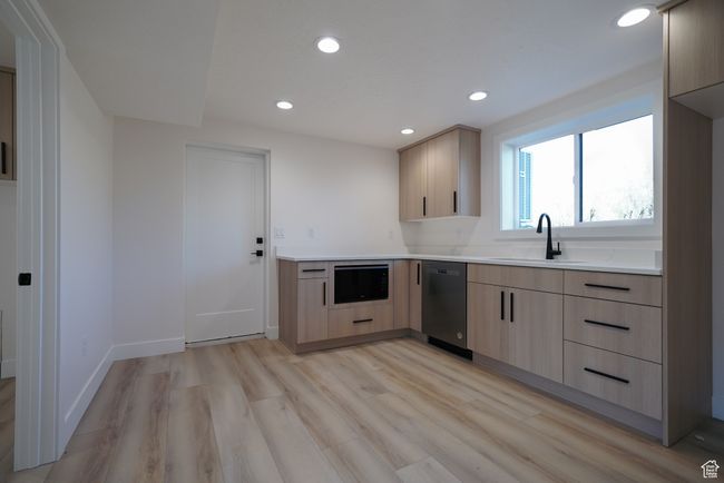 Kitchen with a sink, light brown cabinets, dishwasher, light wood-style flooring, and recessed lighting | Image 21