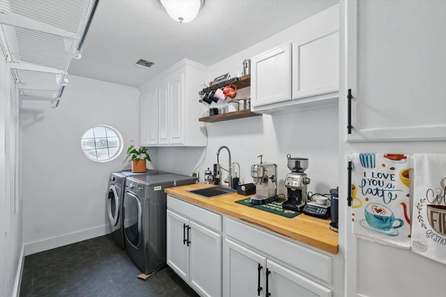 LARGE laundry room with coffee bar, sink and lots of additional storage. | Image 32