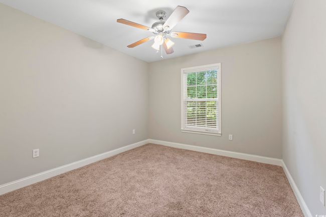 Spare room with carpet floors, baseboards, and ceiling fan | Image 17