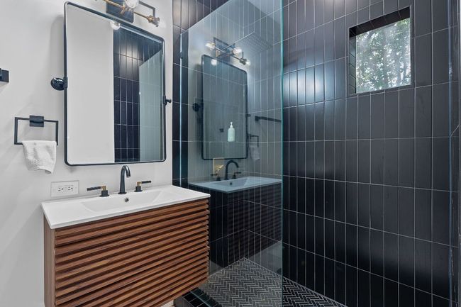 Bathroom featuring a walk in shower and vanity | Image 26