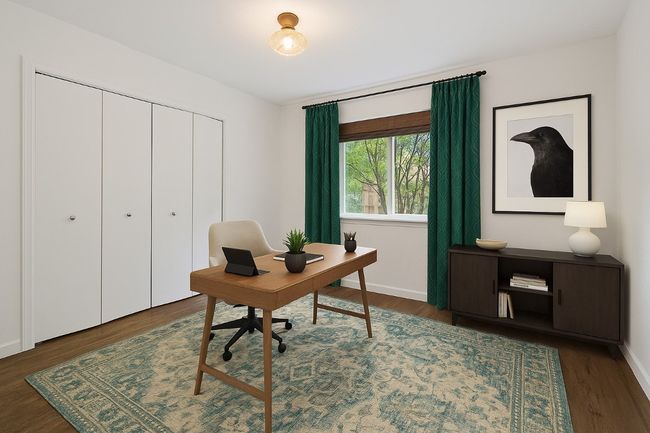 Bedroom #2 with a view to the lush backyard is virtually staged/revisioned as an office. | Image 17