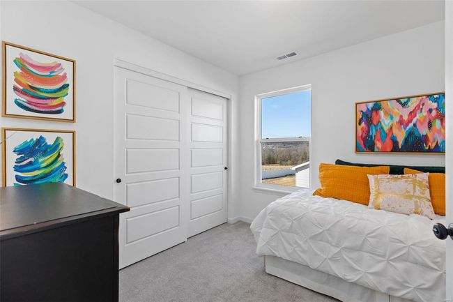 Carpeted bedroom with a closet | Image 27