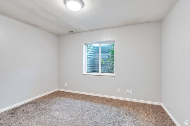 Empty room with visible vents, baseboards, and carpet | Image 26