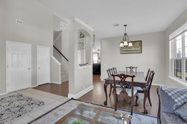 Dining space featuring stairway, tile patterned flooring, visible vents, and baseboards | Image 23