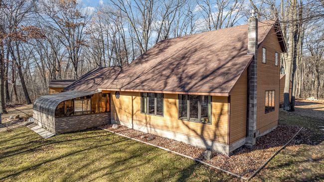 A view of the main house and sunroom from the front. This is where you'll find the private well (tested in 2022) and the septic drain field (pumped 2023). | Image 37