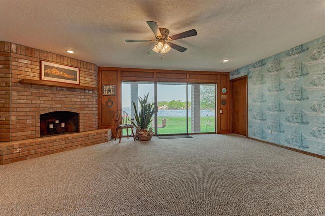 This generously sized first-floor room provides flexible space that can easily serve as a game room, secondary living area, home gym, or office. | Image 26