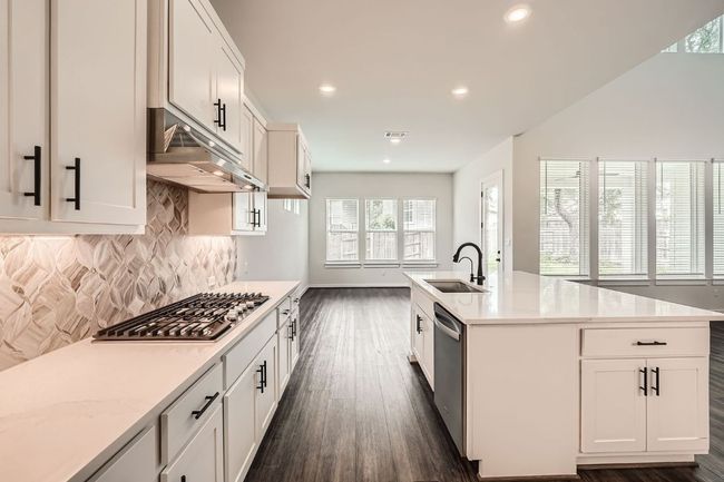 Kitchen with stainless steel appliances, dark wood-style floors, a sink, decorative backsplash, and recessed lighting | Image 10