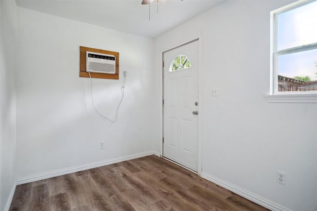 Building #1 featuring wood finished floors, a ceiling fan, and a wall unit AC | Image 22