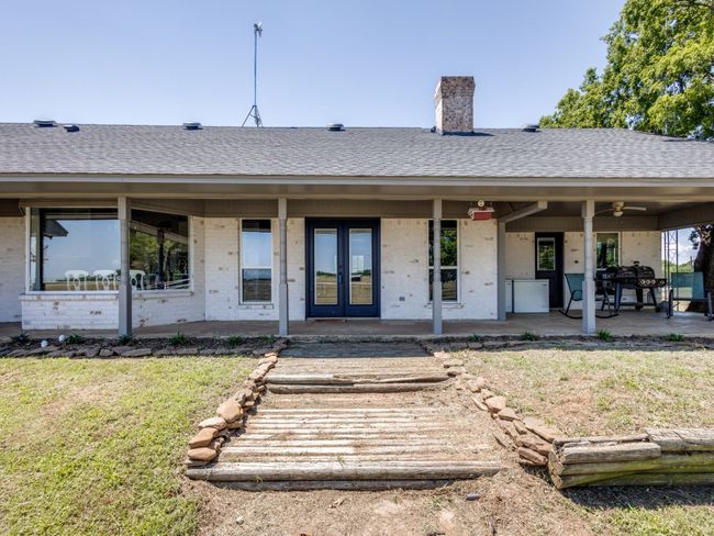 Huge back porch is the perfect place to enjoy living in the country. Enjoy a Texas sunrise or sunset from your covered back patio. Enjoy the view of your acreage and the sounds of your animals and the wildlife. | Image 34