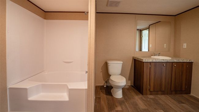 Full bath featuring wood finished floors and vanity | Image 9