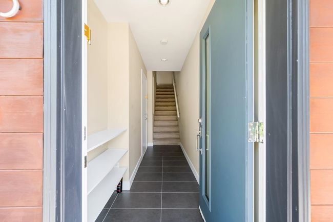 Interior space with dark tile patterned floors, baseboards, stairs, and recessed lighting | Image 20