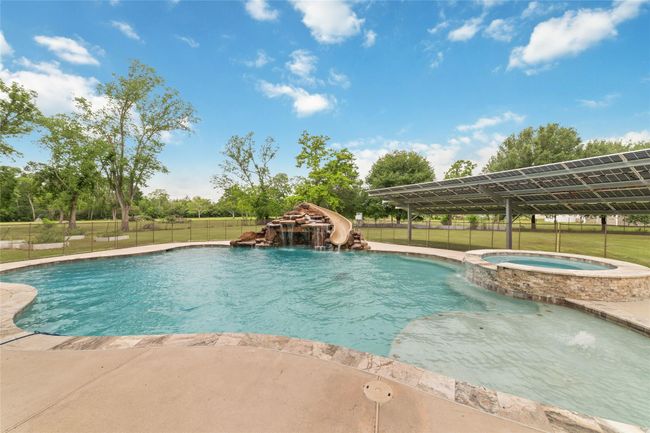 Tucked away on 1.5 serene acres in Manvel, this distinctive property is built for the way you want to live. The flexible floorpan allows between 4 to 6 bedrooms, 2.5 baths, a 2-car garage, in-ground pool, plus a 60'x30' insulated shop. | Image 41