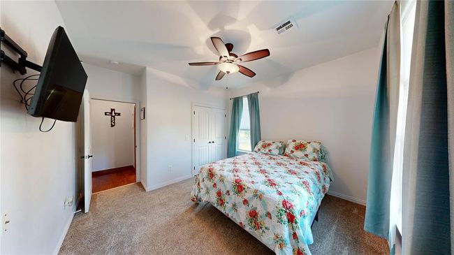 Bedroom with visible vents, a ceiling fan, a closet, baseboards, and carpet flooring | Image 40