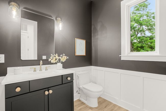 Bathroom featuring wainscoting, toilet, wood finished floors, vanity, and a decorative wall | Image 12