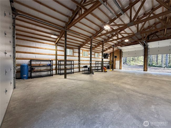 30 and 50 amp power in the garage. Full hookups for trailer or RV. There are power outlets up high in hte corners of the garage for indoor security cameras or more garage heaters. Garage racks stay with the garage. | Image 21