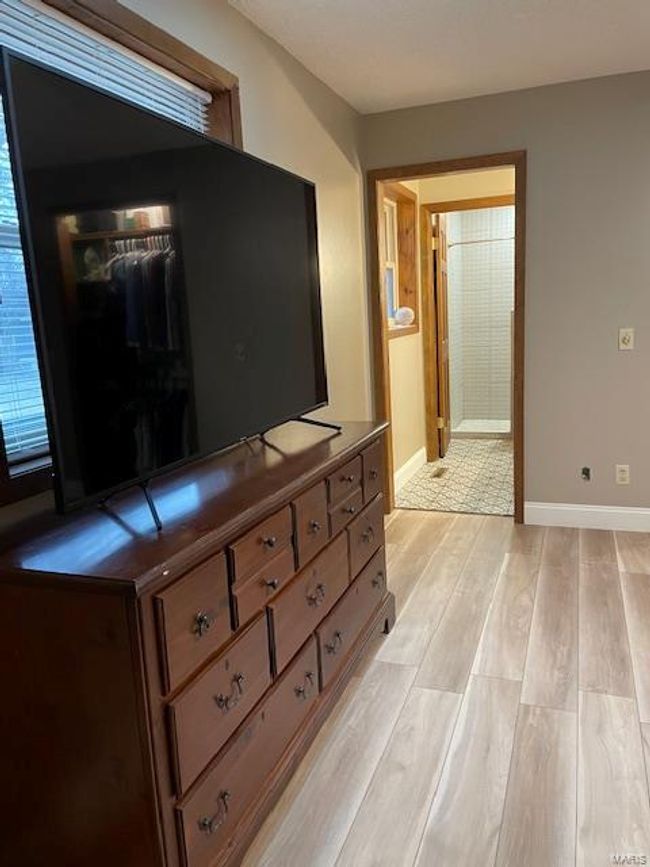 Bedroom with light hardwood / wood-style floors | Image 11