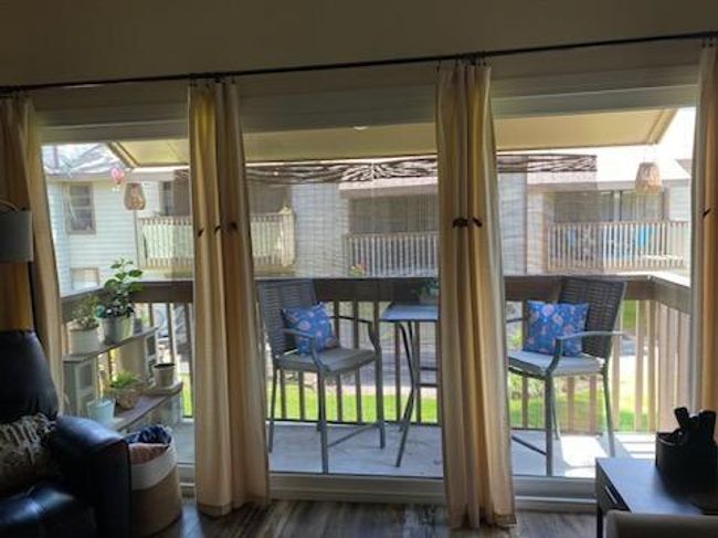 Brand new sliding door and windows in wall of glass opening up to the 2nd story balcony with golf course views. | Image 11