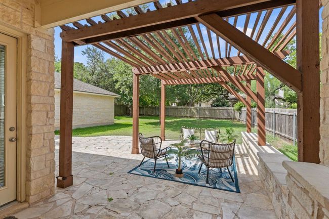 Fenced backyard with a pergola and a patio area | Image 31