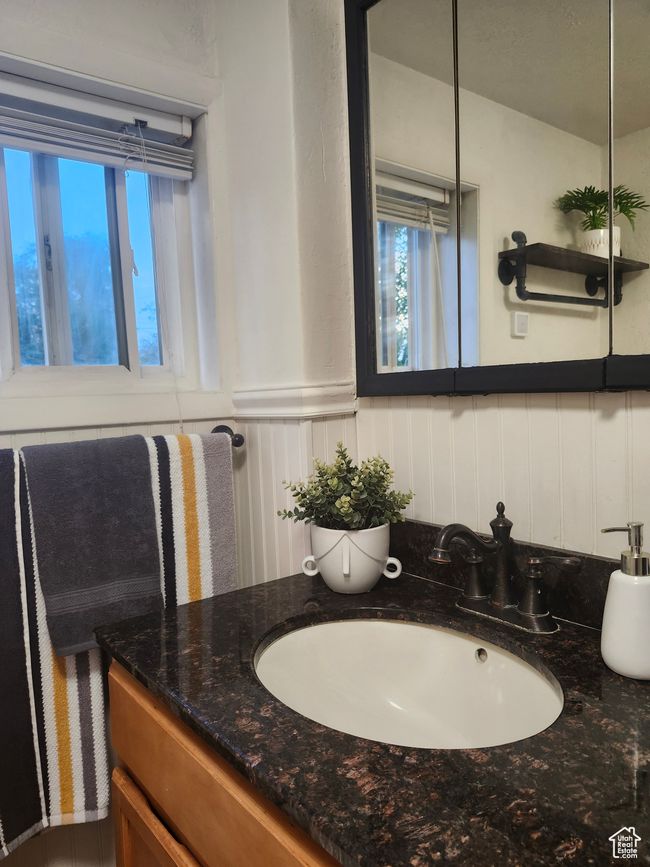 Bathroom with granite vanity and wainscoted wall | Image 24
