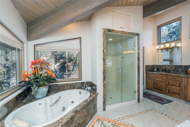 Bathroom featuring vanity, tile patterned floors, vaulted ceiling with beams, wooden ceiling, and shower with separate bathtub | Image 21