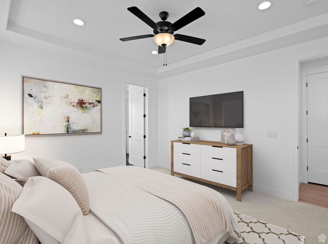 Bedroom featuring baseboards, recessed lighting, a ceiling fan, light carpet, and a tray ceiling | Image 5