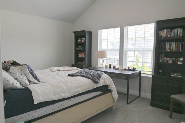 Bedroom featuring vaulted ceiling and light carpet | Image 25
