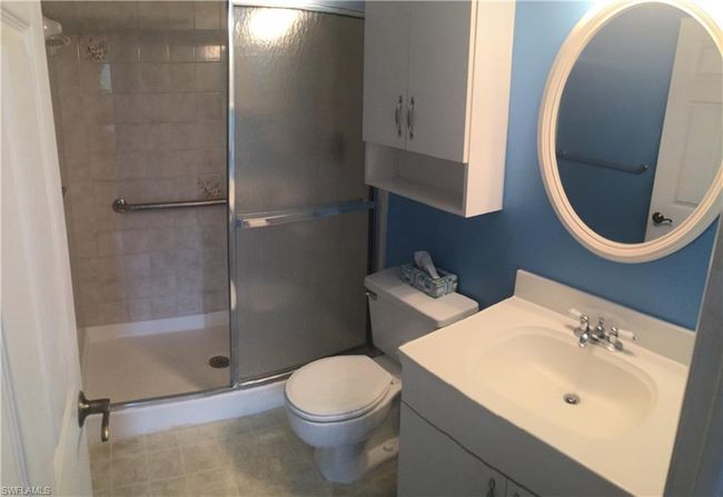 Bathroom with a shower stall and vanity | Image 8