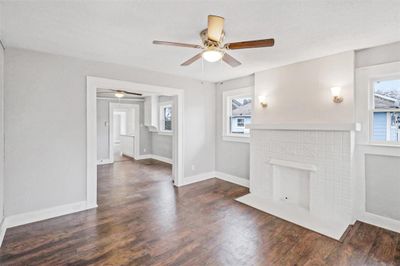 Unfurnished living room featuring dark hardwood / wood-style flooring, a wealth of natural light, and ceiling fan- Previous photos | Image 2