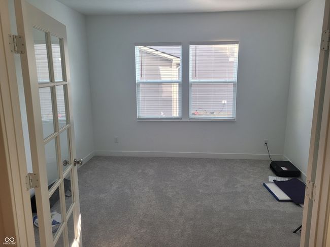 carpeted spare room featuring healthy amount of natural light and french doors | Image 7