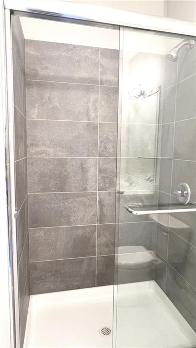 Designer-selected tile completes this lower-level shower. | Image 47