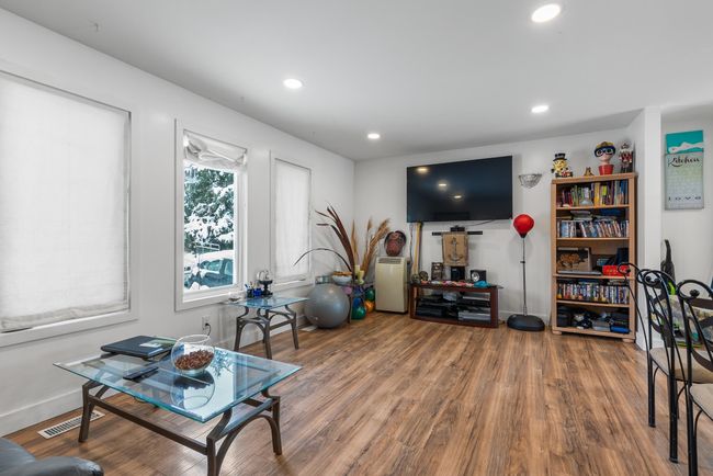 Living room featuring recessed lighting, visible vents, baseboards, and wood finished floors | Image 11