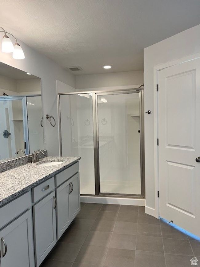 Full bath featuring vanity, visible vents, recessed lighting, a stall shower, and tile patterned flooring | Image 8