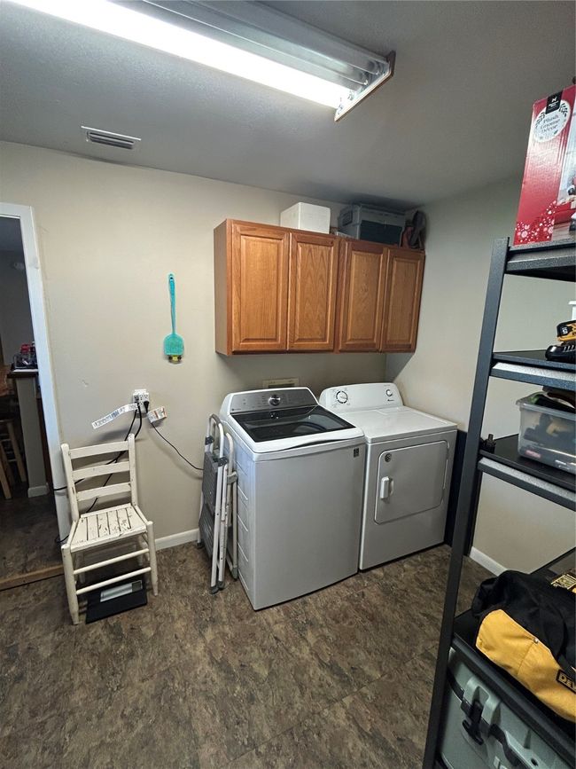 Washroom featuring cabinet space and separate washer and dryer | Image 24