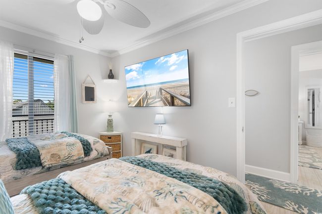 Bedroom featuring crown molding, wood finished floors, baseboards, and a ceiling fan | Image 19