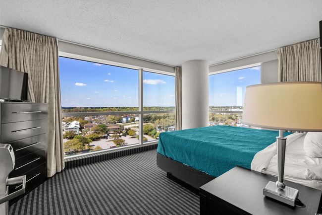 Carpeted bedroom with multiple windows and a textured ceiling | Image 23