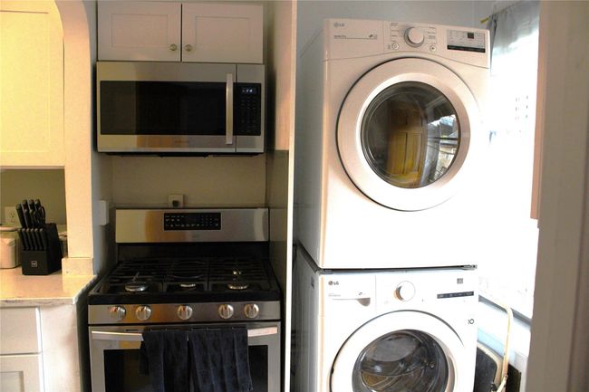 Laundry room with stacked washing machine and dryer | Image 4