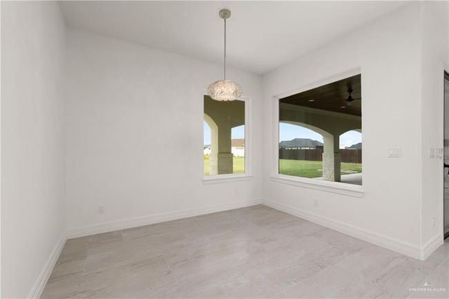 Tranquil Primary Retreat with Patio AccessSpacious and serene, this primary bedroom features large picture windows and sliding glass doors that open directly to the covered back patio—perfect for morning coffee or evening breezes. | Image 14
