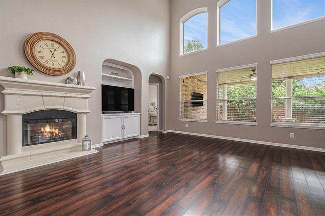 The arches are reflected in the nook that houses the entertainment center with storage, and the walkway to the primary suite! | Image 8
