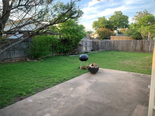 View of yard featuring a fenced backyard and a patio | Image 28