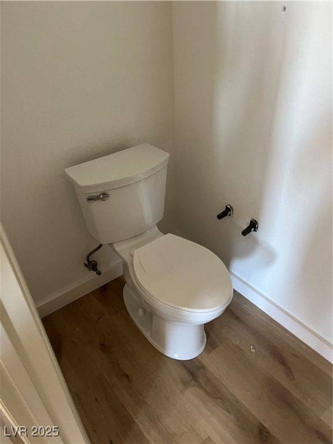 Bathroom featuring wood finished floors, toilet, and baseboards | Image 18