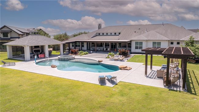 View of pool with a gazebo, a lawn, a patio, and a pool with connected hot tub | Image 23