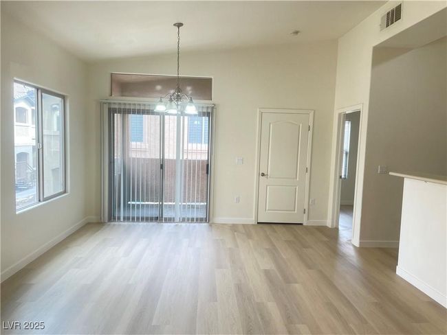 Unfurnished dining area with a chandelier, light wood finished floors, and plenty of natural light | Image 5