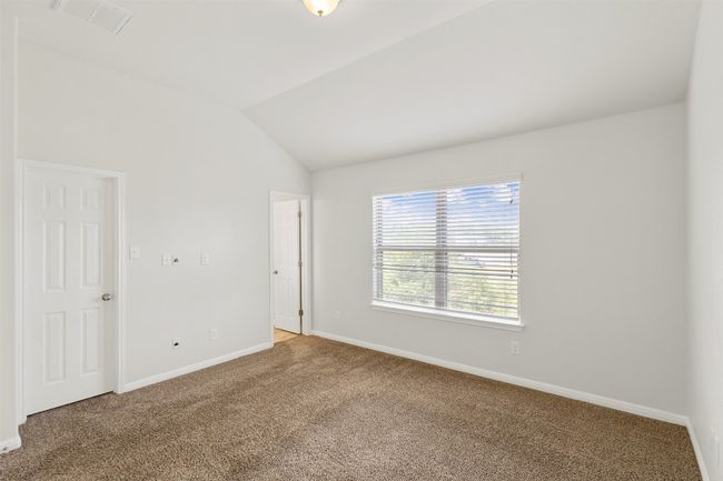 Carpeted empty room with baseboards and vaulted ceiling | Image 18
