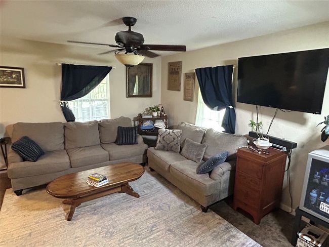 Living area with plenty of natural light, a ceiling fan, and a textured ceiling | Image 14