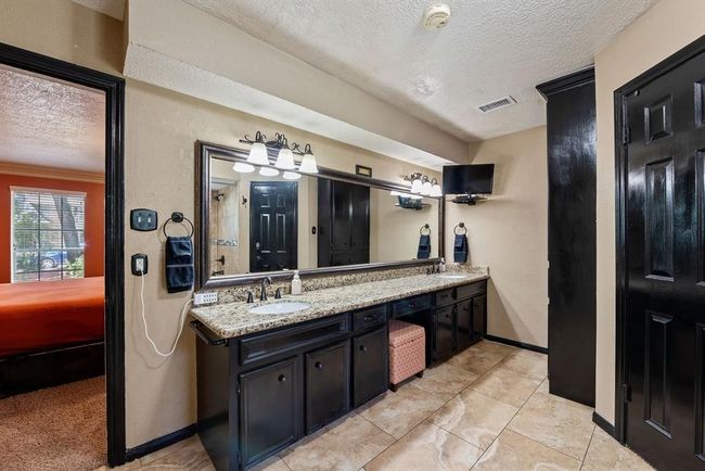 Updates include granite counter with dual sinks, faucets, light fixtures, and mirrors. | Image 21