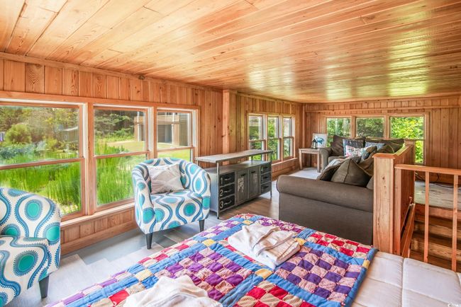 Living room featuring wooden ceiling, wood walls, and wood finished floors | Image 11